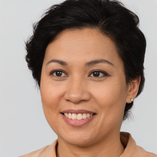 Joyful latino young-adult female with short  brown hair and brown eyes