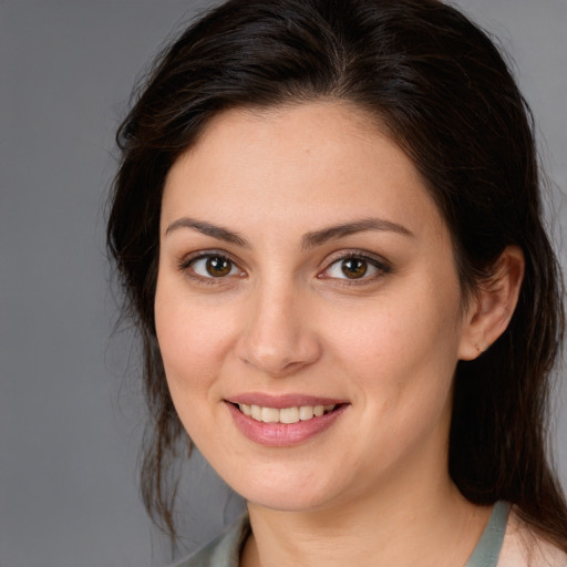 Joyful white young-adult female with medium  brown hair and brown eyes