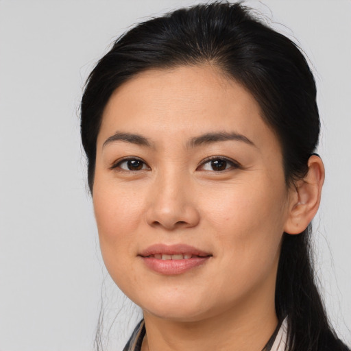 Joyful asian young-adult female with long  brown hair and brown eyes