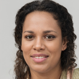 Joyful black young-adult female with long  brown hair and brown eyes