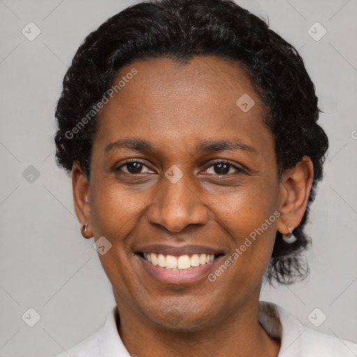 Joyful black adult female with short  brown hair and brown eyes