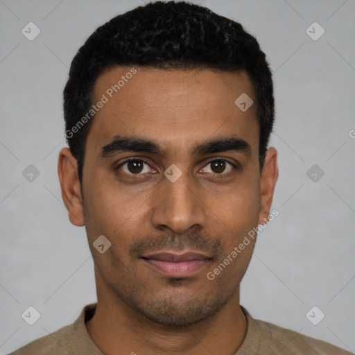 Joyful latino young-adult male with short  black hair and brown eyes