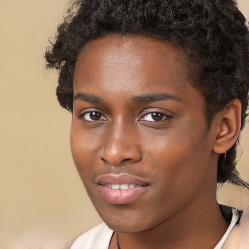 Joyful black young-adult male with short  brown hair and brown eyes