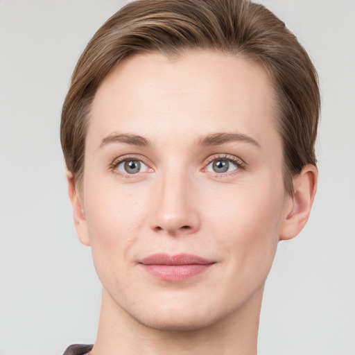 Joyful white young-adult female with short  brown hair and grey eyes