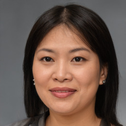 Joyful asian young-adult female with medium  brown hair and brown eyes