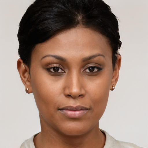 Joyful latino young-adult female with short  brown hair and brown eyes