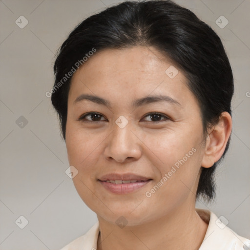 Joyful asian adult female with medium  brown hair and brown eyes