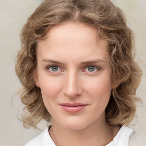 Joyful white young-adult female with medium  brown hair and green eyes