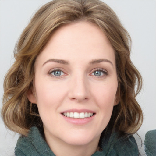 Joyful white young-adult female with medium  brown hair and blue eyes