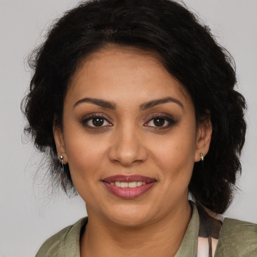 Joyful latino young-adult female with medium  brown hair and brown eyes