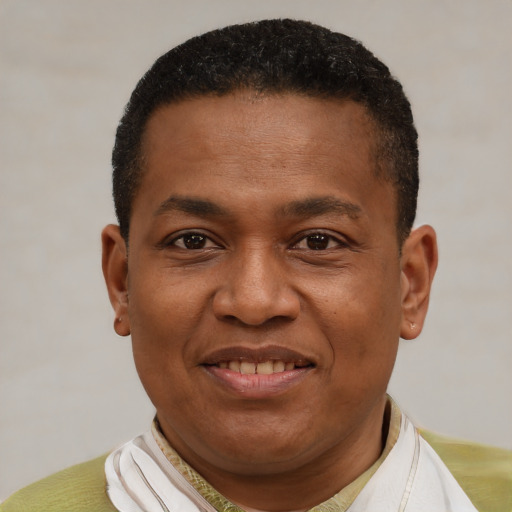 Joyful latino adult male with short  black hair and brown eyes