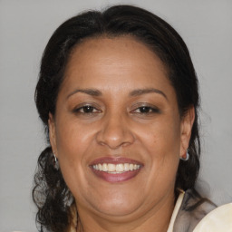 Joyful black adult female with medium  brown hair and brown eyes