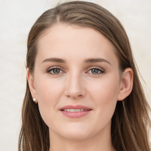 Joyful white young-adult female with long  brown hair and grey eyes