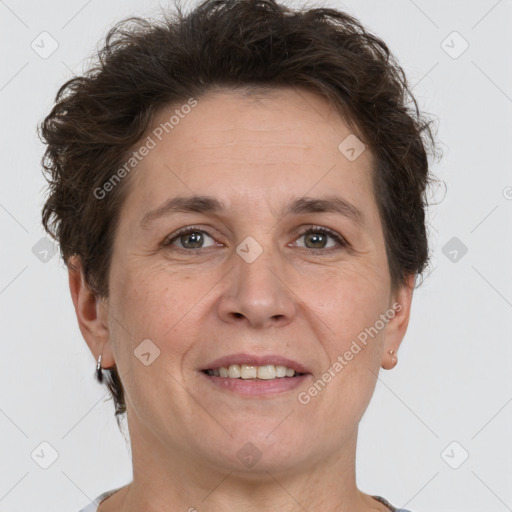 Joyful white adult female with short  brown hair and brown eyes