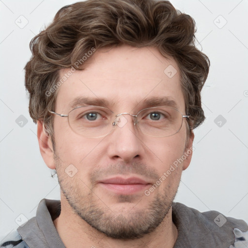 Joyful white adult male with short  brown hair and grey eyes