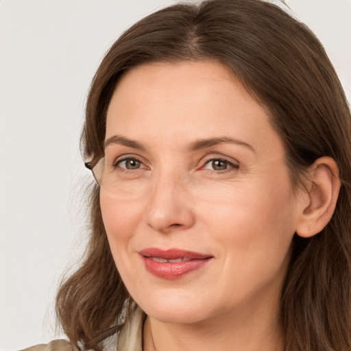 Joyful white adult female with long  brown hair and brown eyes