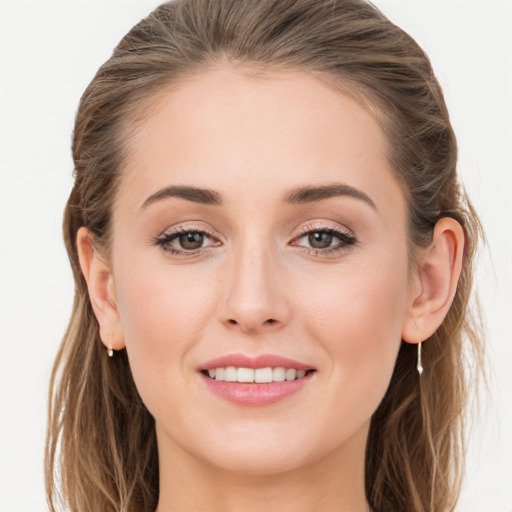 Joyful white young-adult female with long  brown hair and grey eyes