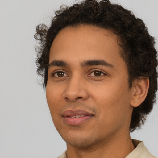 Joyful latino young-adult male with short  brown hair and brown eyes