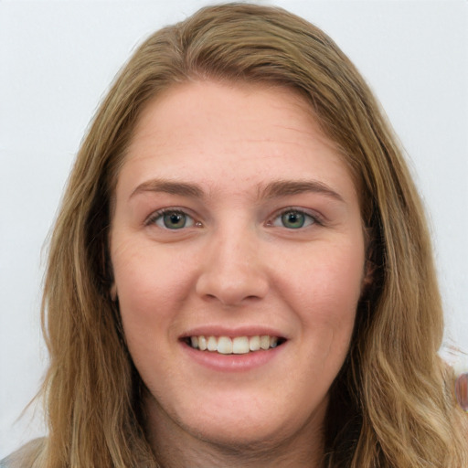 Joyful white young-adult female with long  brown hair and blue eyes