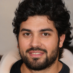 Joyful white young-adult male with short  black hair and brown eyes