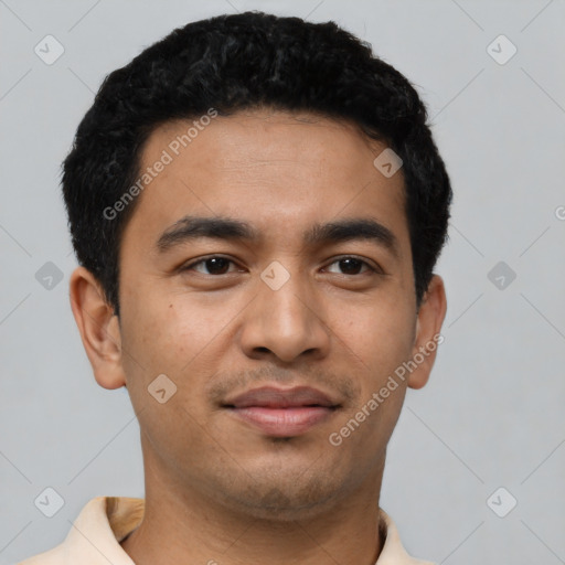 Joyful latino young-adult male with short  black hair and brown eyes