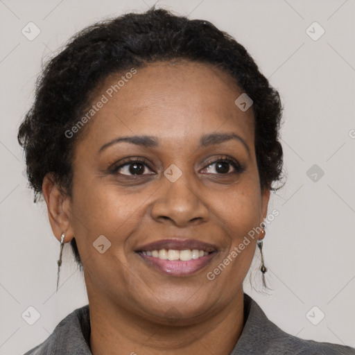 Joyful black adult female with short  brown hair and brown eyes