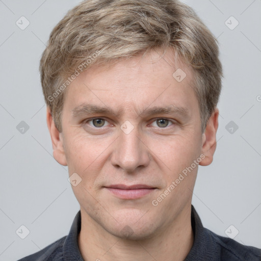 Joyful white adult male with short  brown hair and grey eyes