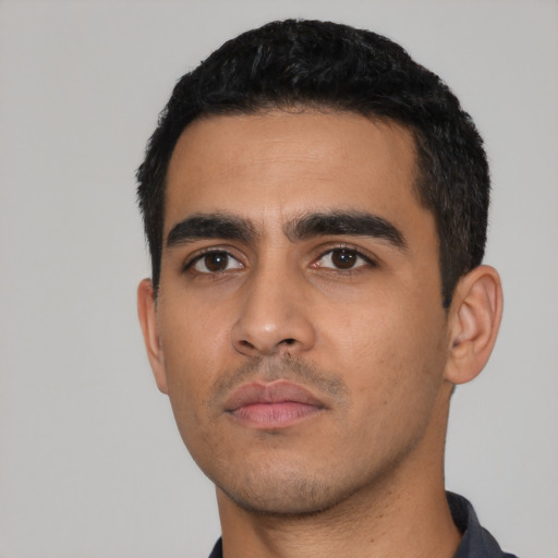 Neutral latino young-adult male with short  black hair and brown eyes