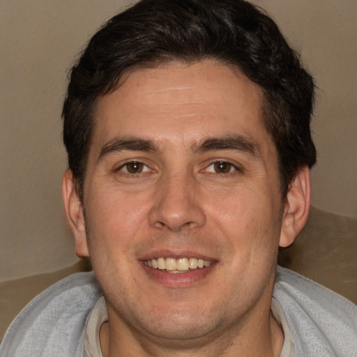 Joyful white adult male with short  brown hair and brown eyes