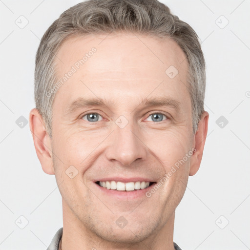 Joyful white adult male with short  brown hair and grey eyes