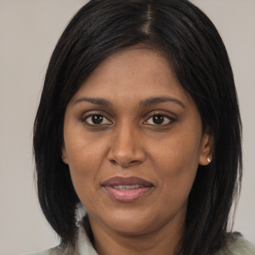 Joyful asian adult female with medium  black hair and brown eyes