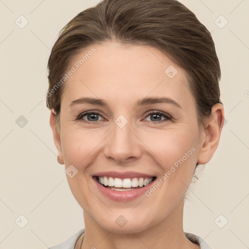 Joyful white young-adult female with short  brown hair and grey eyes