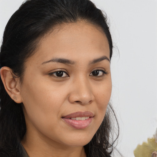 Joyful latino young-adult female with long  brown hair and brown eyes