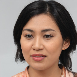 Joyful asian young-adult female with medium  black hair and brown eyes