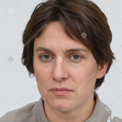 Joyful white adult female with medium  brown hair and grey eyes