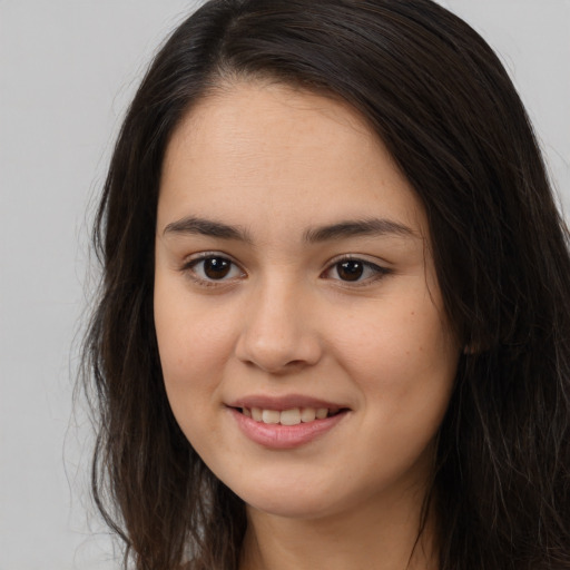 Joyful asian young-adult female with long  brown hair and brown eyes