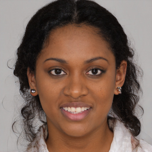 Joyful black young-adult female with medium  black hair and brown eyes