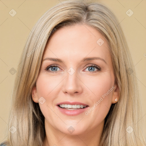 Joyful white adult female with long  brown hair and blue eyes