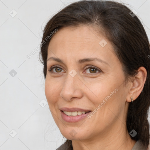 Joyful white adult female with medium  brown hair and brown eyes