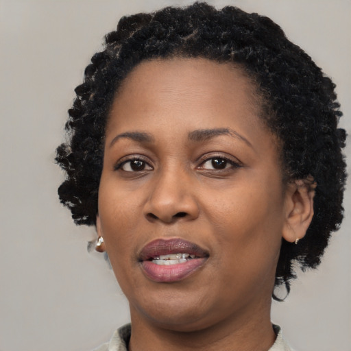 Joyful black adult female with short  black hair and brown eyes
