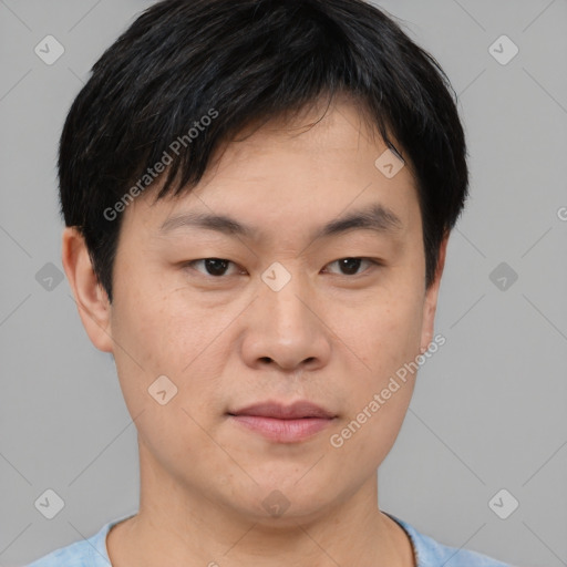 Joyful asian young-adult male with short  black hair and brown eyes