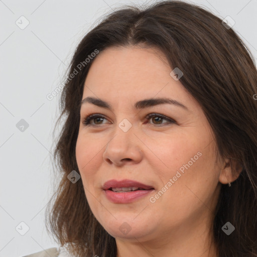 Joyful white adult female with medium  brown hair and brown eyes