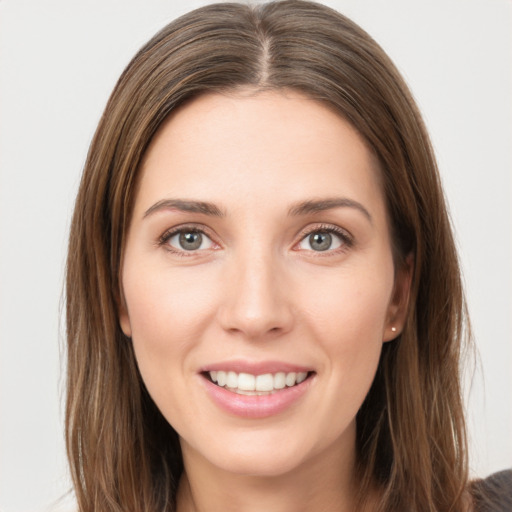 Joyful white young-adult female with long  brown hair and grey eyes