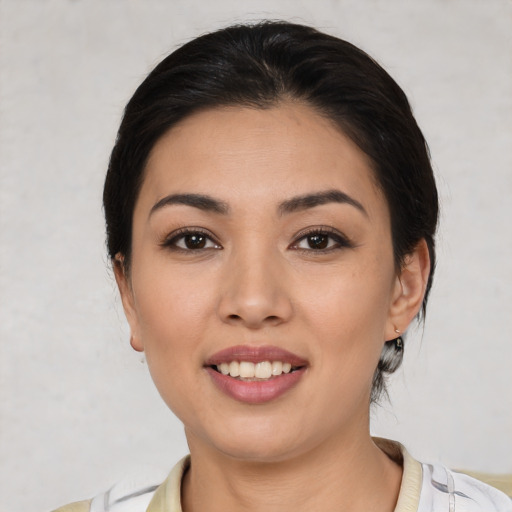 Joyful white young-adult female with medium  black hair and brown eyes