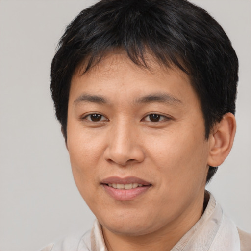 Joyful asian adult female with short  brown hair and brown eyes