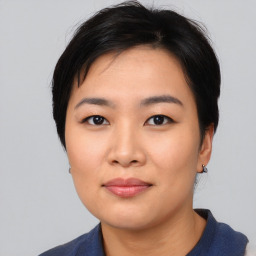 Joyful asian young-adult female with short  black hair and brown eyes