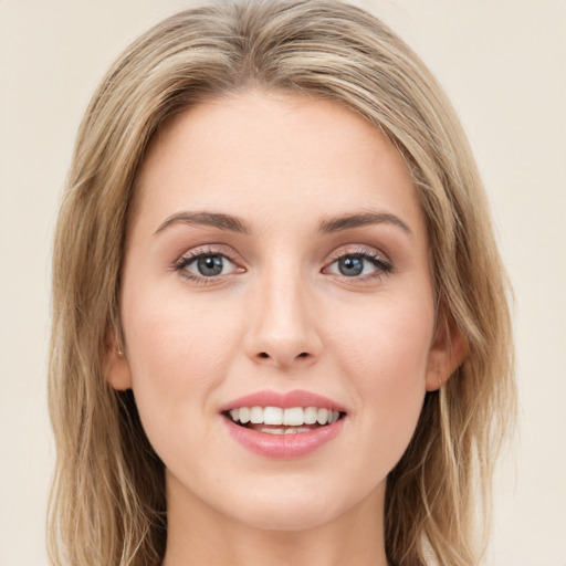 Joyful white young-adult female with long  brown hair and green eyes