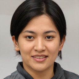 Joyful asian young-adult female with medium  black hair and brown eyes