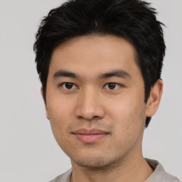 Joyful asian young-adult male with short  black hair and brown eyes