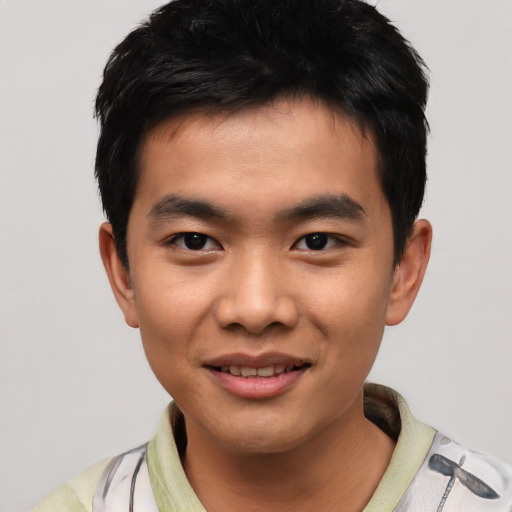 Joyful asian young-adult male with short  black hair and brown eyes